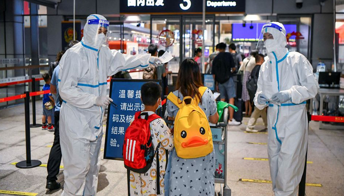 Tourists who were stranded amid the new outbreak of the coronavirus disease (COVID-19) arrive at the departure hall of Haikou Meilan International Airport in Haikou, Hainan province, China August 11, 2022. — Reuters