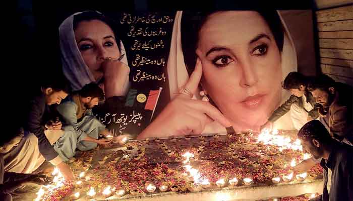 Workers of Pakistan Peoples Party (PPP) light candles to pay tribute to former prime minister Benazir Bhutto on the occasion of her 15th death anniversary in front of Larkana Press Club, December 26. —APP