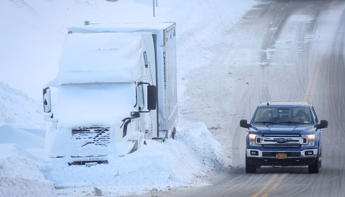 Vehicles are left stranded on the road following a winter storm that hit the Buffalo region in Amherst, New York, US, December 25, 2022 — Reuters