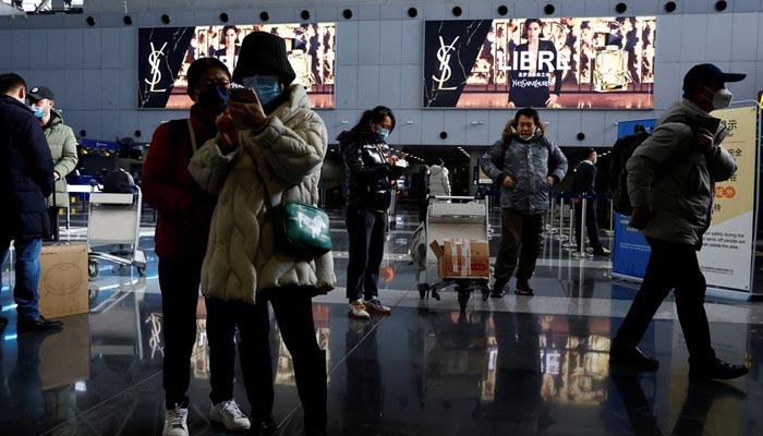 Travellers stand by their luggage at Beijing Capital International Airport, amid the coronavirus disease (COVID-19) outbreak in Beijing, China December 27, 2022. — Reuters