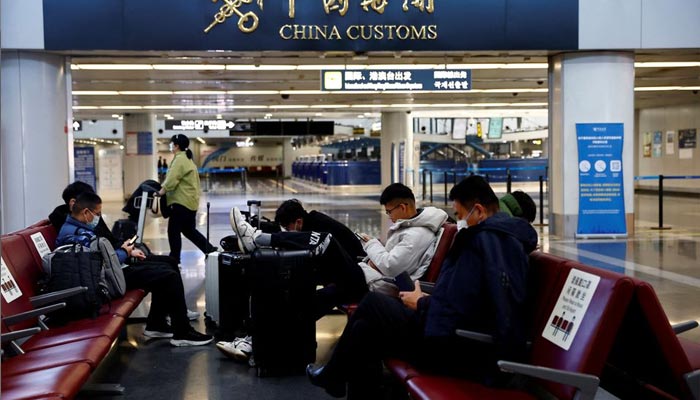 Travellers wait with their luggage at Beijing Capital International Airport, amid the coronavirus disease (COVID-19) outbreak in Beijing, China December 27, 2022. — Reuters