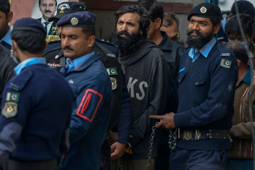Pakistani-American Zahir Jaffer (centre), convicted to murder Noor Mukadam, arrives in a court before the case verdict in Islamabad on February 24, 2022. — AFP