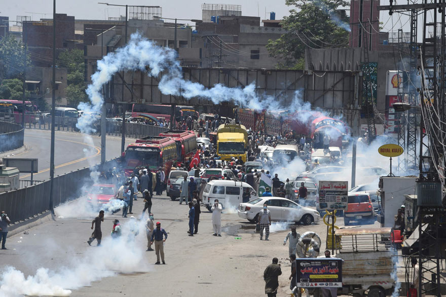 Police use tear gas to disperse activists of the PTI of ousted prime minister Imran Khan during a protest in Lahore on May 25, 2022, as all roads leading into Pakistan´s capital were blocked ahead of a major protest planned by ousted prime minister Imran Khan and his supporters. — AFP