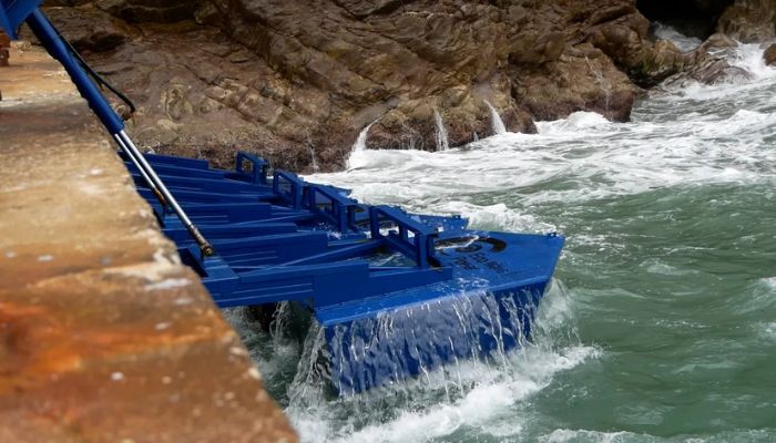Blue metal floaters attached to an old World War II ammo jetty in Gibraltars coastline oscillate up and down, converting the moderate rise and fall of waves into renewable electricity.— Eco Wave Power