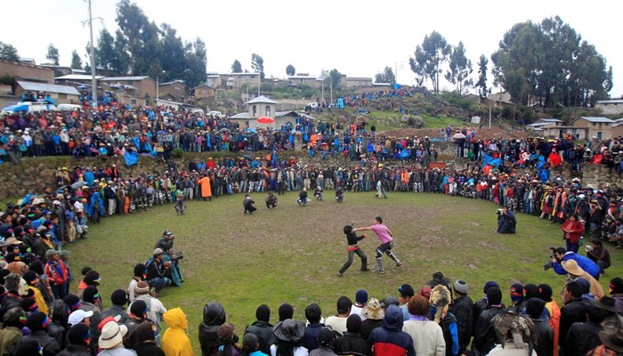 Andean men participate in a one-on-one fight during the Takanakuy, a traditional festivity at Chumbivilcas province, in Cuzco, December 25, 2011 — REUTERS