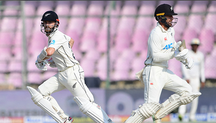 New Zealands Kane Williamson (L) and Tom Blundell run between the wickets during the third day of the first Test match between Pakistan and New Zealand at the National stadium in Karachi on December 28, 2022. — AFP