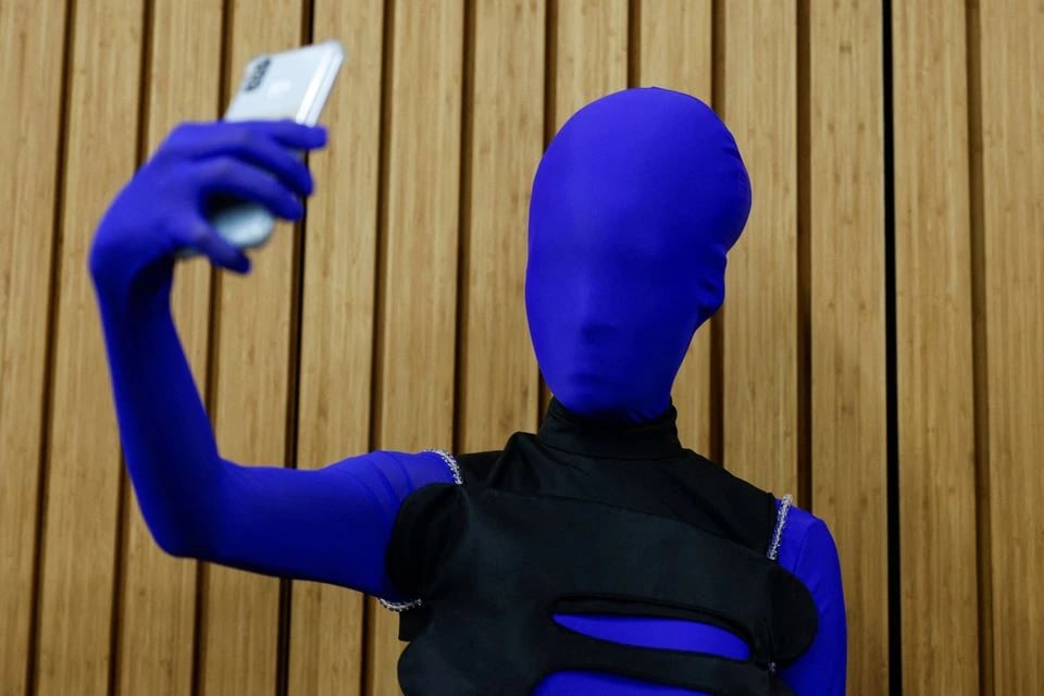 A model takes selfie at backstage before the first designer-led AI Fashion X AI : Call For Young Talents 2022 fashion show in Hong Kong, China, December 19, 2022. — Reuters
