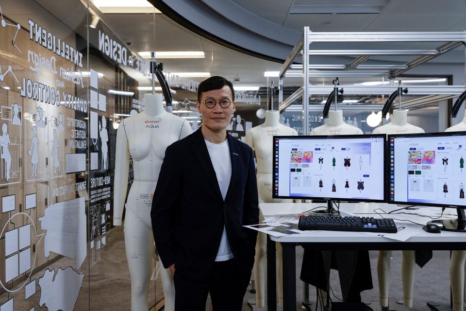 Chief Executive Officer and Centre Director of AiDALab, professor Calvin Wong poses with Aida system, before the Fashion X AI : Call For Young Talents 2022 fashion show in Hong Kong, China, December 16, 2022.— Reuters