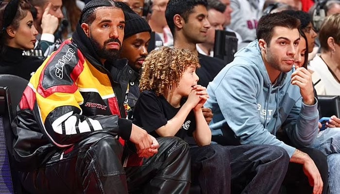 Drake gives a warm hug to son Adonis during NBA game