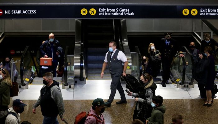 People enter the baggage claim area from the international arrivals terminal as the U.S. reopens air and land borders to coronavirus disease (COVID-19) vaccinated travellers for the first time since the COVID-19 restrictions were imposed, at Sea-Tac Airport in Seattle, Washington, U.S. November 8, 2021.— Reuters