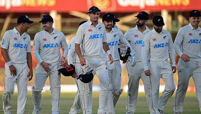 New Zealands captain Tim Southee (centre) along with his teammates walk back to the pavilion at the end of fourth-day play of the first Test match between Pakistan and New Zealand at the National Stadium in Karachi on December 29, 2022. — AFP