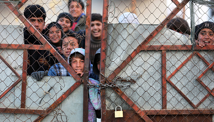 Afghan people stand in queues to receive food aid from a non-governmental organisation (NGO) in Kabul on December 25, 2022. — AFP