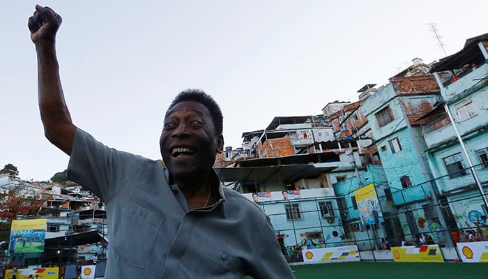 Pele poses for the media during the inauguration of a refurbished football field at the Mineira slum in Rio de Janeiro, Brazil, September 10, 2014. — Reuters
