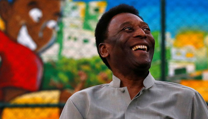 Brazilian soccer legend Pele laughs during the inauguration of a refurbished soccer field at the Mineira slum in Rio de Janeiro September 10, 2014. REUTERS