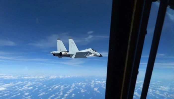 A Chinese Navy J-11 fighter jet is recorded flying close to a U.S. Air Force RC-135 aircraft in international airspace over the South China Sea, according to the U.S. military, in a still image from video taken December 21, 2022.— Reuters