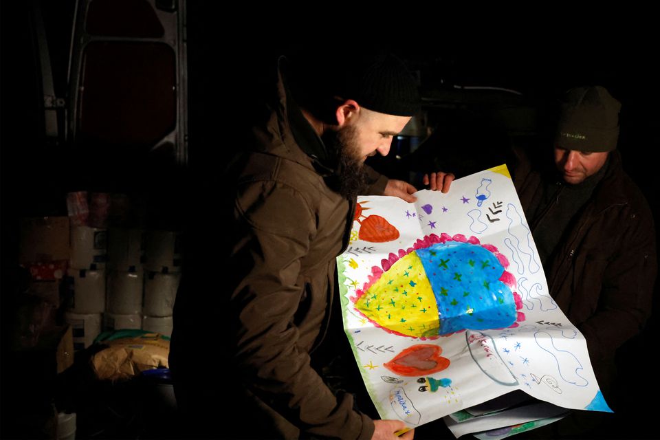Ukrainian Border Guards receive drawings from school children, among donations of food and gifts from their families and people in general, as Russias attack on Ukraine continues, in Sloviansk, Ukraine, December 29, 2022.— Reuters