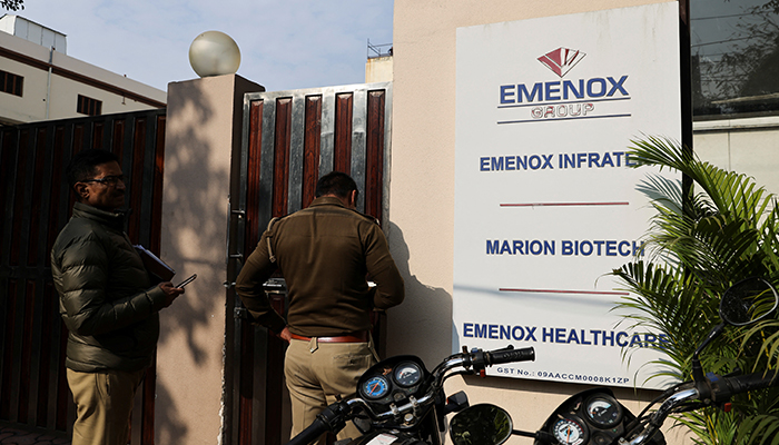 Police are seen at the gate of an office of Marion Biotech, a healthcare and pharmaceutical company and a part of the Emenox Group in Noida, India, December 29, 2022. — AFP