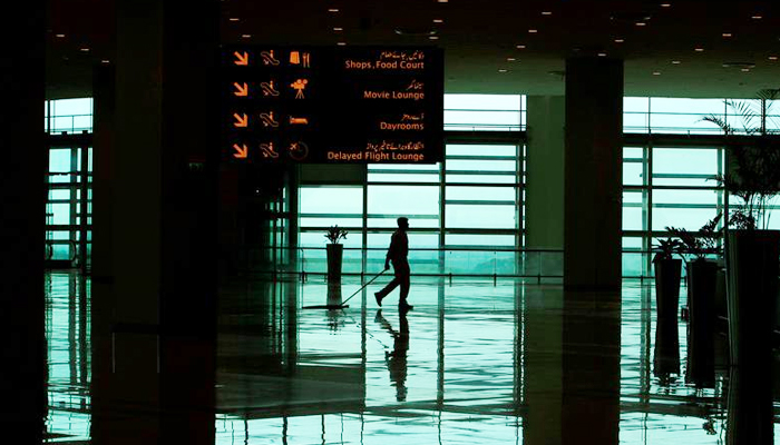 A worker cleans the floor of the Islamabad International Airport on April 18, 2018. — Reuters
