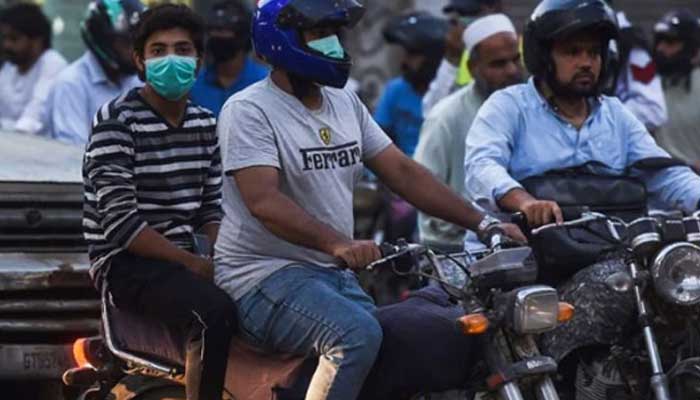 Men seen pillion riding in Pakistan. — AFP/File