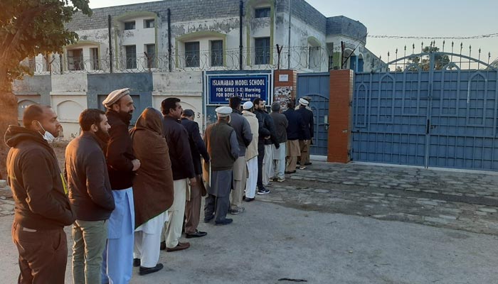 Voters stand outside polling station in Islamabad on December 31, 2022. — Twitter/ fawadchaudhry