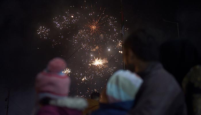1 جنوری 2023 کے اوائل کو کراچی میں نئے سال کی تقریبات کے دوران آتش بازی کا مظاہرہ دیکھ رہے ہیں۔ — اے ایف پی