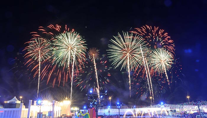 Fireworks light the sky during a light and drone show to celebrate the New Year in Al Wathba, near Abu Dhabi on December 31, 2022. — AFP