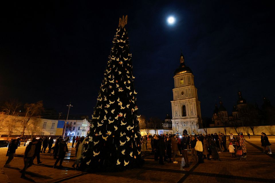People gathered next to a Christmas tree to celebrate the New Year eve before a curfew, amid Russias attack on Ukraine, in front of the St. Sophia Cathedral in Kyiv, Ukraine December 31, 2022.— Reuters