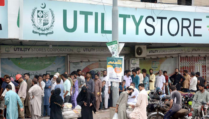 A long queue of people is seen outside a utility store. — APP/File