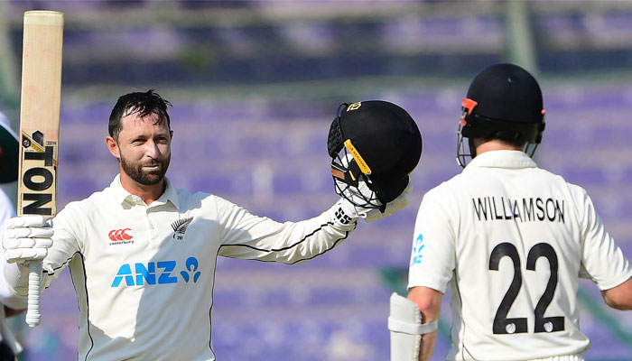New Zealand's Devon Conway (L) celebrates after scoring a century during the first day of the second Test between Pakistan and New Zealand at the National Bank Cricket Arena in Karachi on January 2, 2023. —AFP