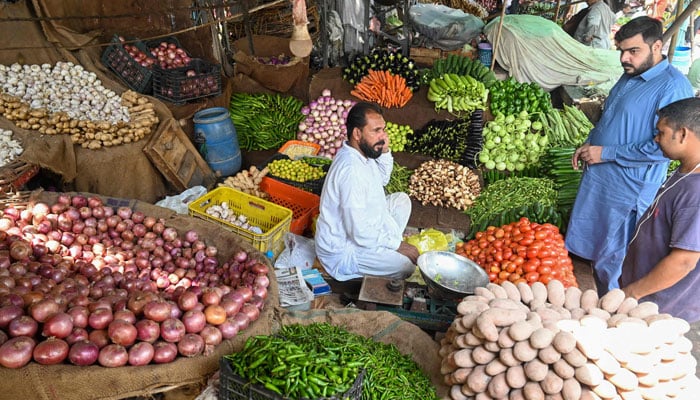 An undated image of consumers buying fresh vegetables from a local. — AFP/File