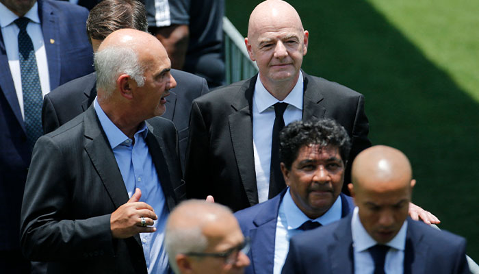 FIFA President Gianni Infantino is pictured with mourners, as the body of Brazilian soccer legend Pele lays in state on the pitch of his former club Santos Vila Belmiro stadium. — Reuters