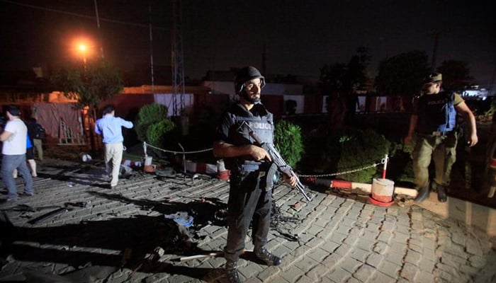 A policeman stands guard after a blast in Lahore, Pakistan August 7, 2017. — Reuters