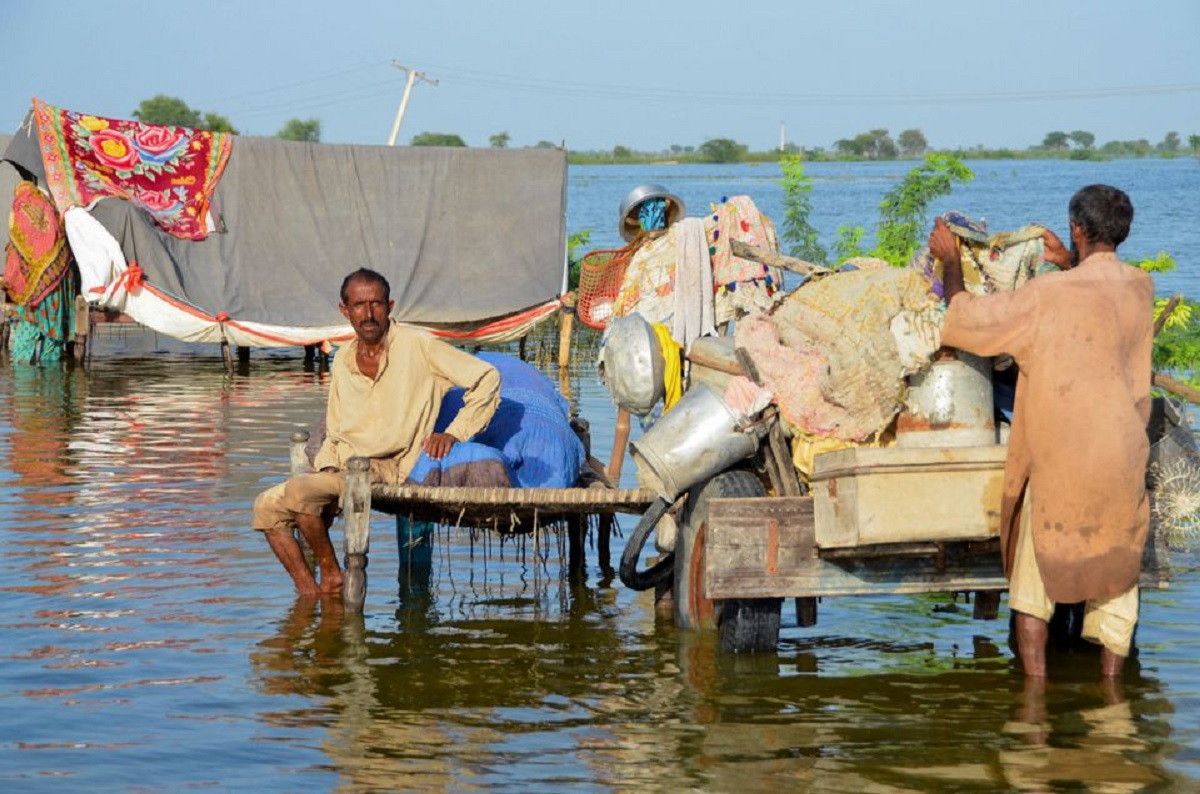 A family of flood victims takes refuge with their belongings as floodwater rises, following rains and floods during the monsoon season in Sohbatpur, September 4, 2022. — Reuters