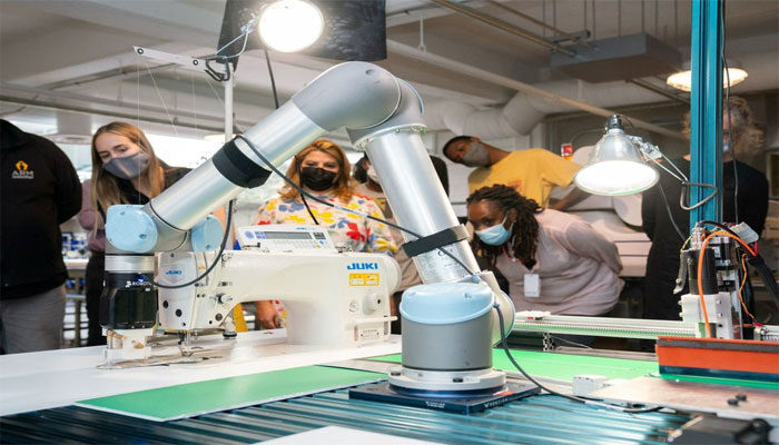 A robotic arm positions pieces of stiffened fabric for a demonstration of automated sewing at the Industrial Sewing and Innovation Center in Detroit, Michigan, US. — Reuters/File