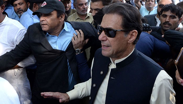 PTI Chairman Imran Khan arrives for hearing at a court. — AFP/File