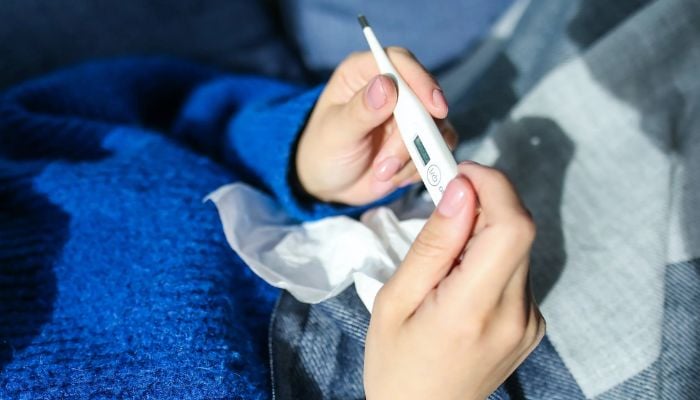 A Person Holding Thermometer.— Pexels