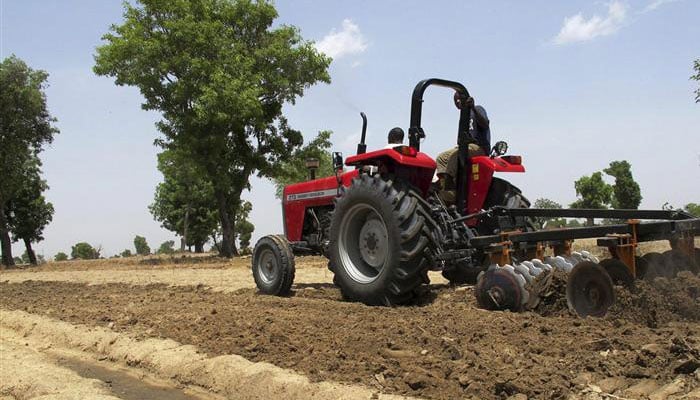 A farmer ploughs his field with a tractor on the outskirts of the city. — Reuters/File