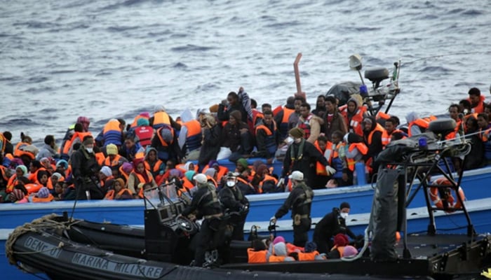 A boat full of migrants waiting during a rescue operation off the coast of Sicily on 20 May, 2014. — AFP