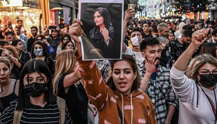 Protesters hold a portrait of Mahsa Amini during a rally in Iran. — AFP/File