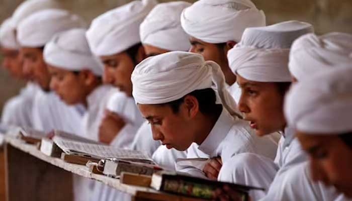 Students recite the Holy Quran at a seminary in Pakistan. — Reuters/File