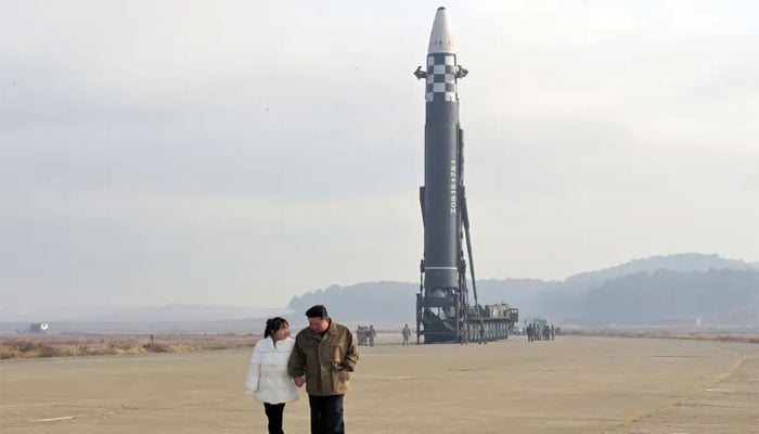 North Korean leader Kim Jong Un walks away from an intercontinental ballistic missile (ICBM) with his daughter in this photo. — Reuters/File