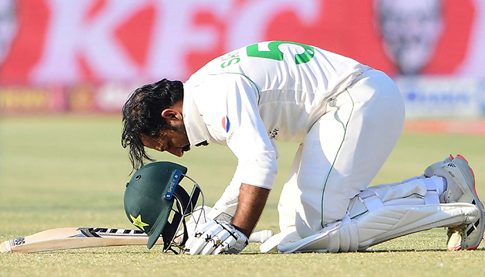 Pakistans Sarfaraz Ahmed bows to celebrate after scoring a century (100 runs) during the fifth and final day of the second cricket Test match between Pakistan and New Zealand at the National Stadium in Karachi on January 6, 2023. — AFP