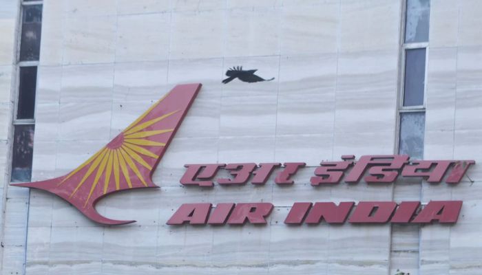 A bird flies over a logo of Air India airlines at the corporate headquarters in Mumbai, India, October 19, 2021.— Reuters