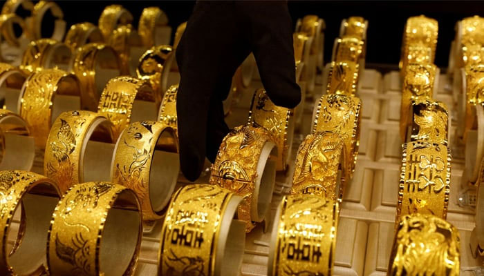 Gold ornaments are displayed in a showcase at a jewellers shop— Reuters/File