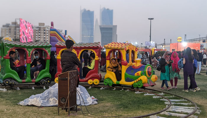 Kids enjoying rides at the Karachi Eat festival with their parents. — reporter