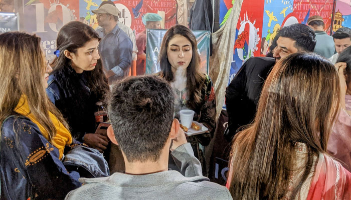 A group of friends enjoying smoky wafers at Icesmokers at Karachi Eat Festival. — reporter