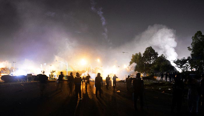 Policemen and PTI supporters clash near the prime ministers residence in Islamabad on August 30, 2014. — AFP