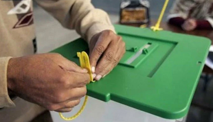 A polling staff member seals a ballot box— APP