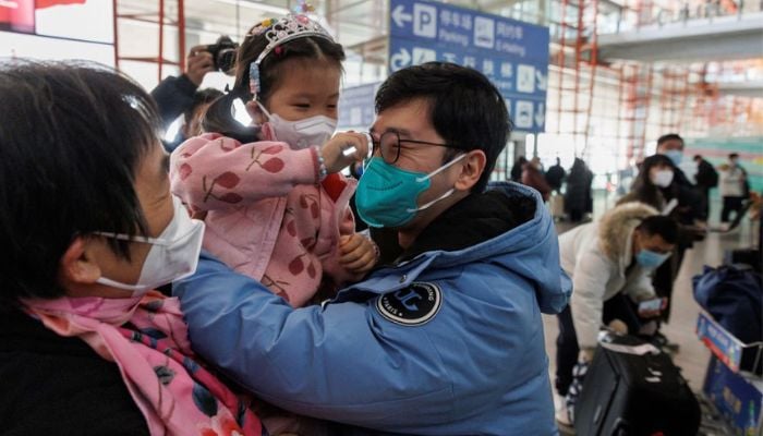 People embrace at international arrivals gate at Beijing Capital International Airport after China lifted coronavirus disease quarantine requirement for inbound travellers in Beijing, January 8, 2023.— Reuters