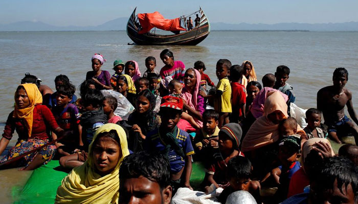Rohingya refugees sit on a makeshift boat as they get interrogated by the Border Guard Bangladesh after crossing the Bangladesh-Myanmar border at Shah Porir Dwip Bangladesh. — Reuters/File